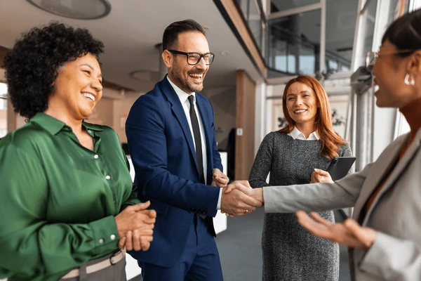 professional-team-engaging-meeting-shaking-600nw-2718088061